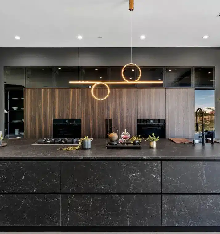 Modern kitchen island with Nero Greco marble countertop and sleek wood cabinets.