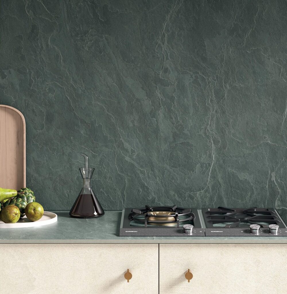 Laminam Amazzonia ceramic surface in deep green with marble-like veining and subtle texture, for modern interior wall cladding and kitchen countertops