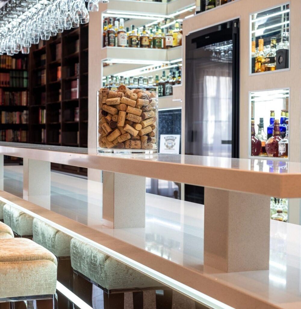 Bright white polished TechniStone Brilliant White surface with a mirror-like structure and subtle sparkle beside a modern bar display.