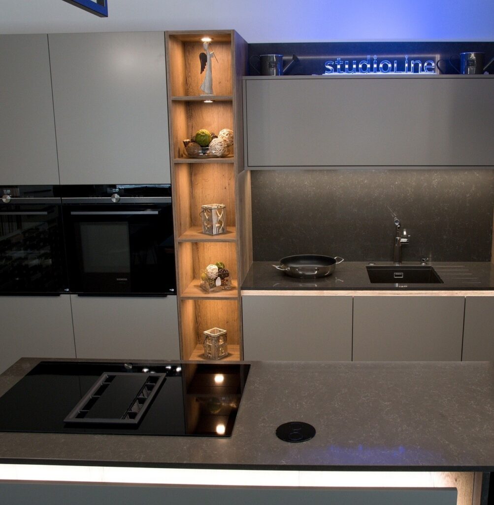 Technistone Noble Pietra Grey quartz kitchen surface in deep grey with delicate white veining and polished gloss across the worktop.