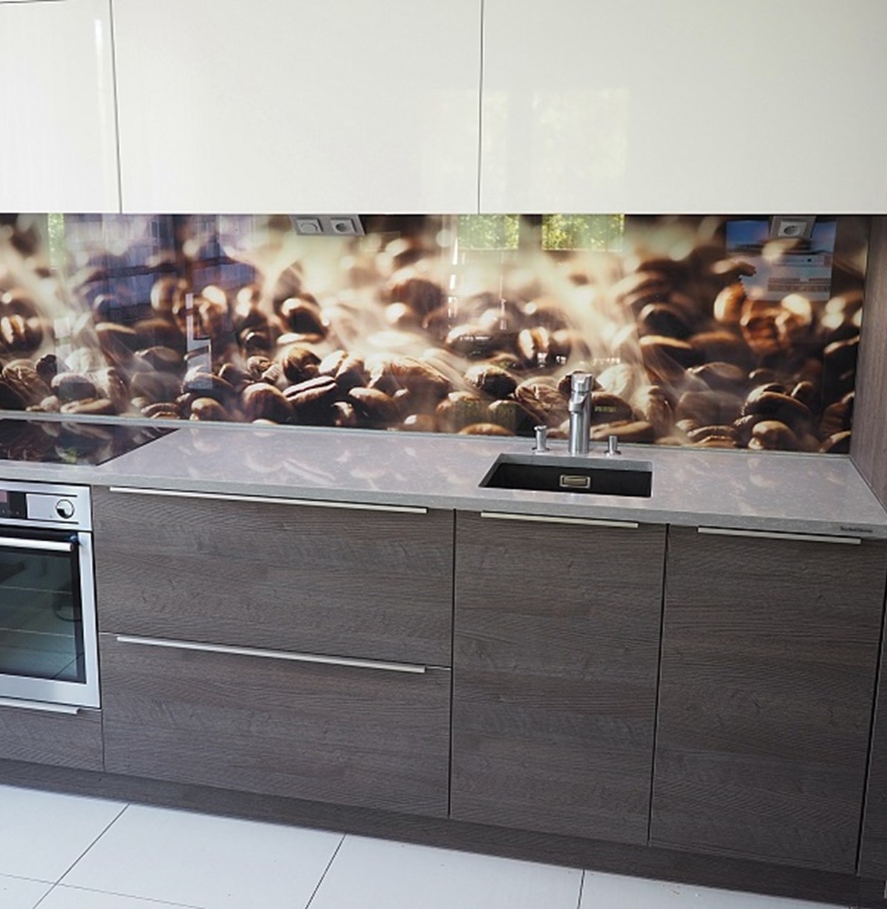 TechniStone Noble Pro Cloud quartz kitchen countertop with soft grey surface and elegant white veining, paired with dark cabinetry and a reflective sink