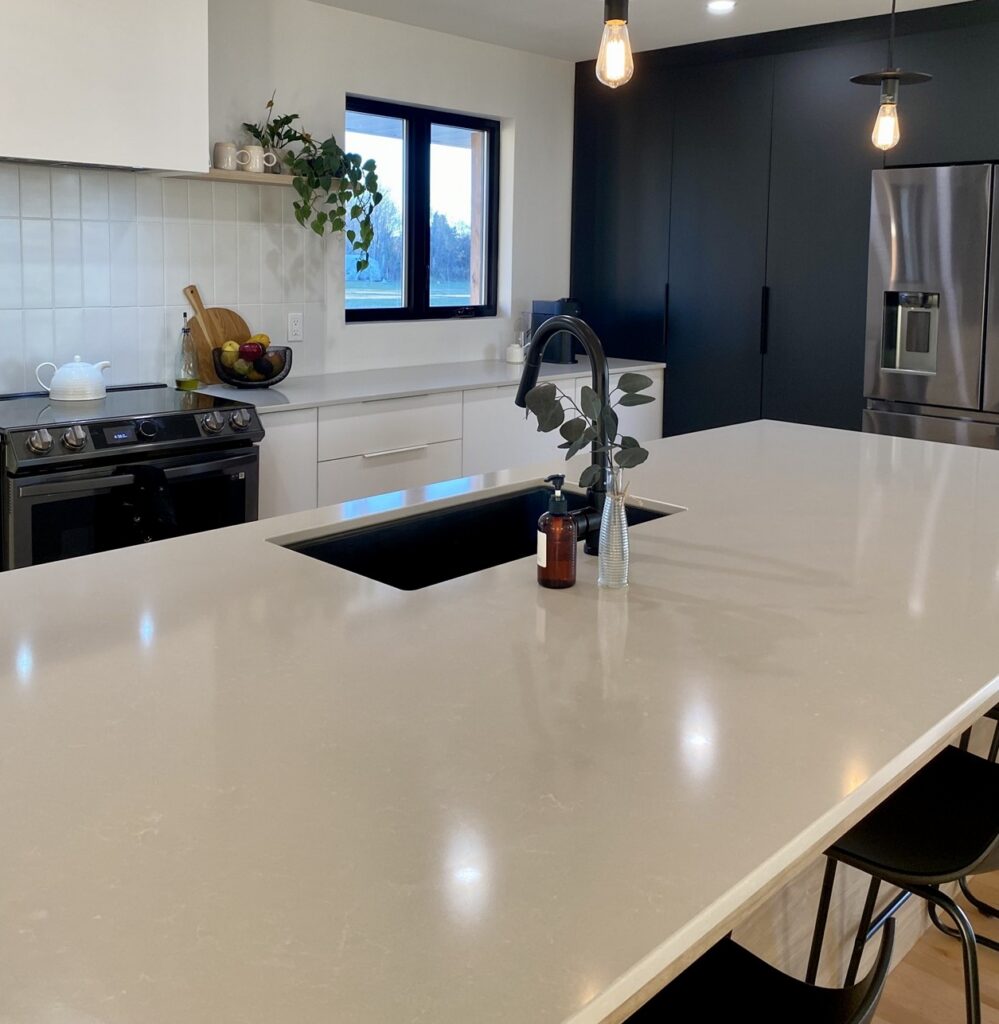 Technistone Noble Pro Frost engineered quartz with a fine white-grain surface and subtle grey veining, finished polished for a glossy look.