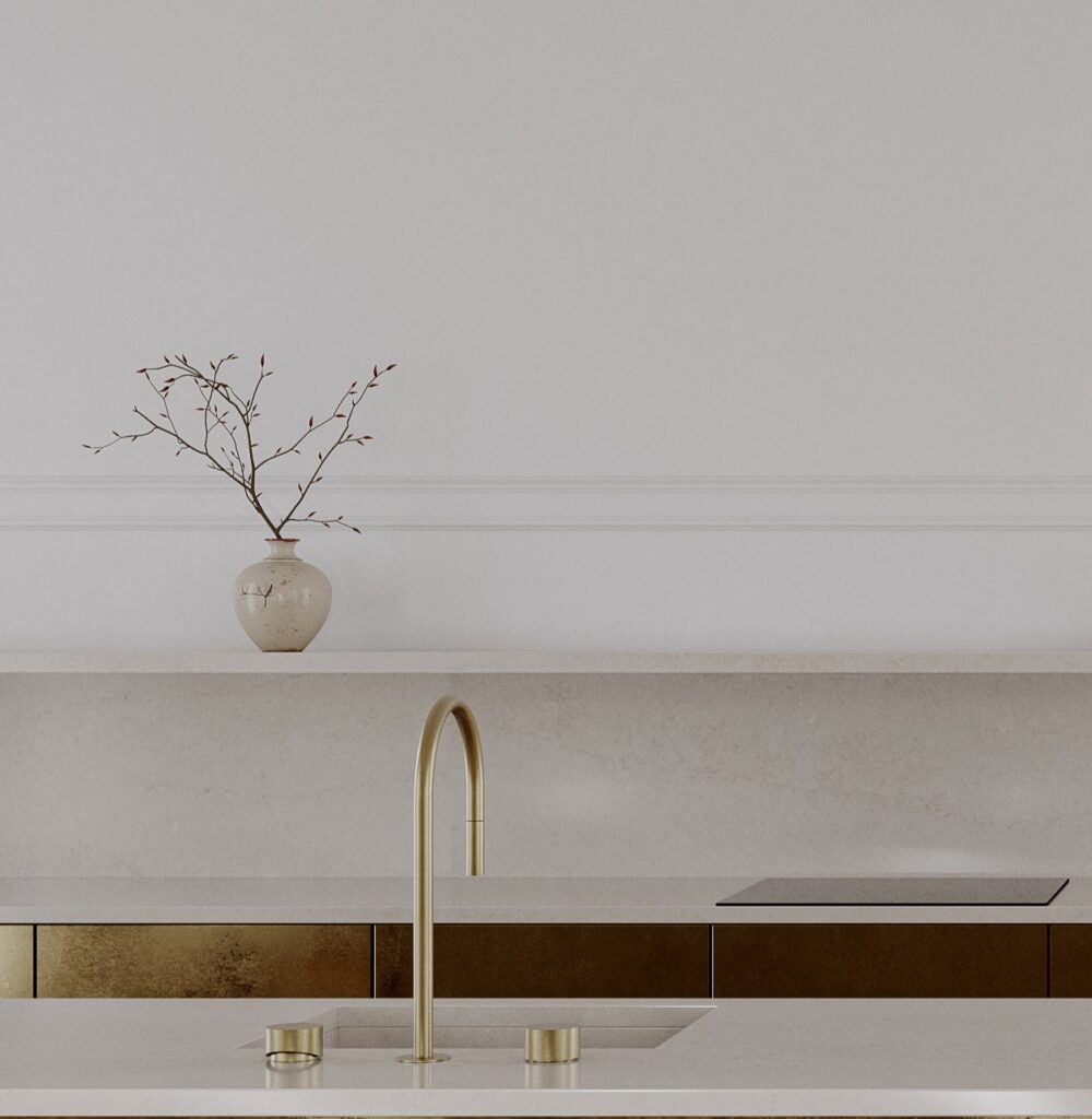 TechniStone Taj Mahal Gold engineered quartz with warm beige and golden tones, elegant veining, light stone backdrop and glossy countertop surface.