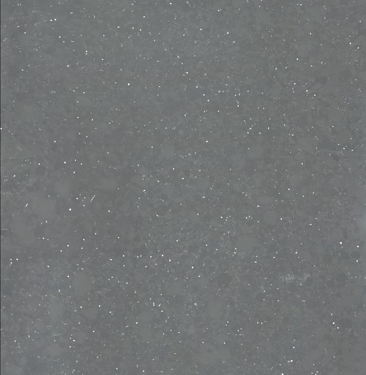 Light quartz surface with recycled decorative fragments and sustainable design character. Custom fabrication by Marmi Futerno.