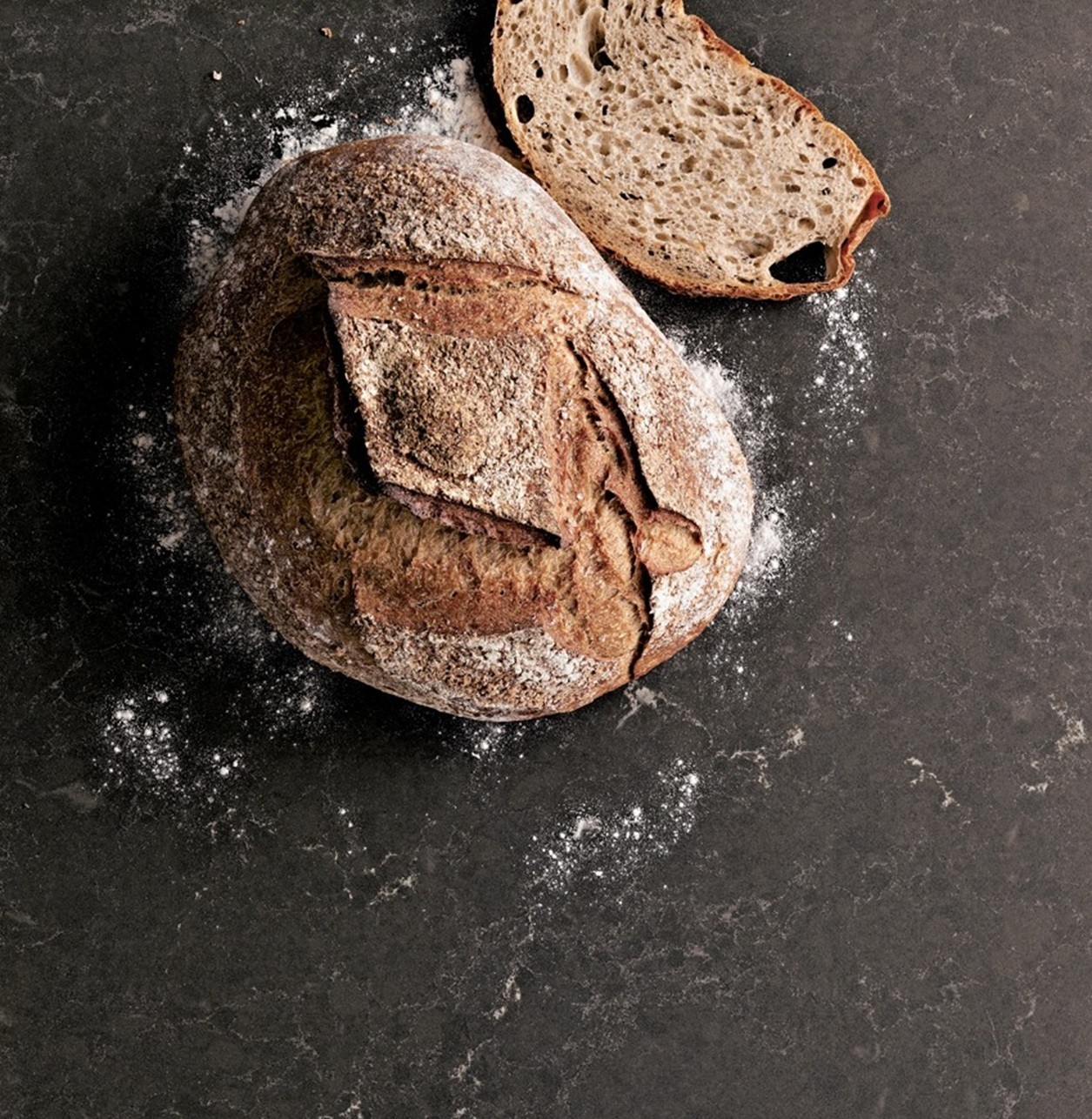 Caesarstone 5003 Piatra Grey countertop with rustic bread and flour