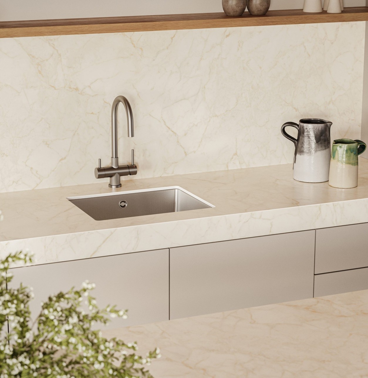 Caesarstone 507 Marbannova porcelain shows a warm white surface with golden veining, paired with a modern kitchen sink, tap and light cabinetry.