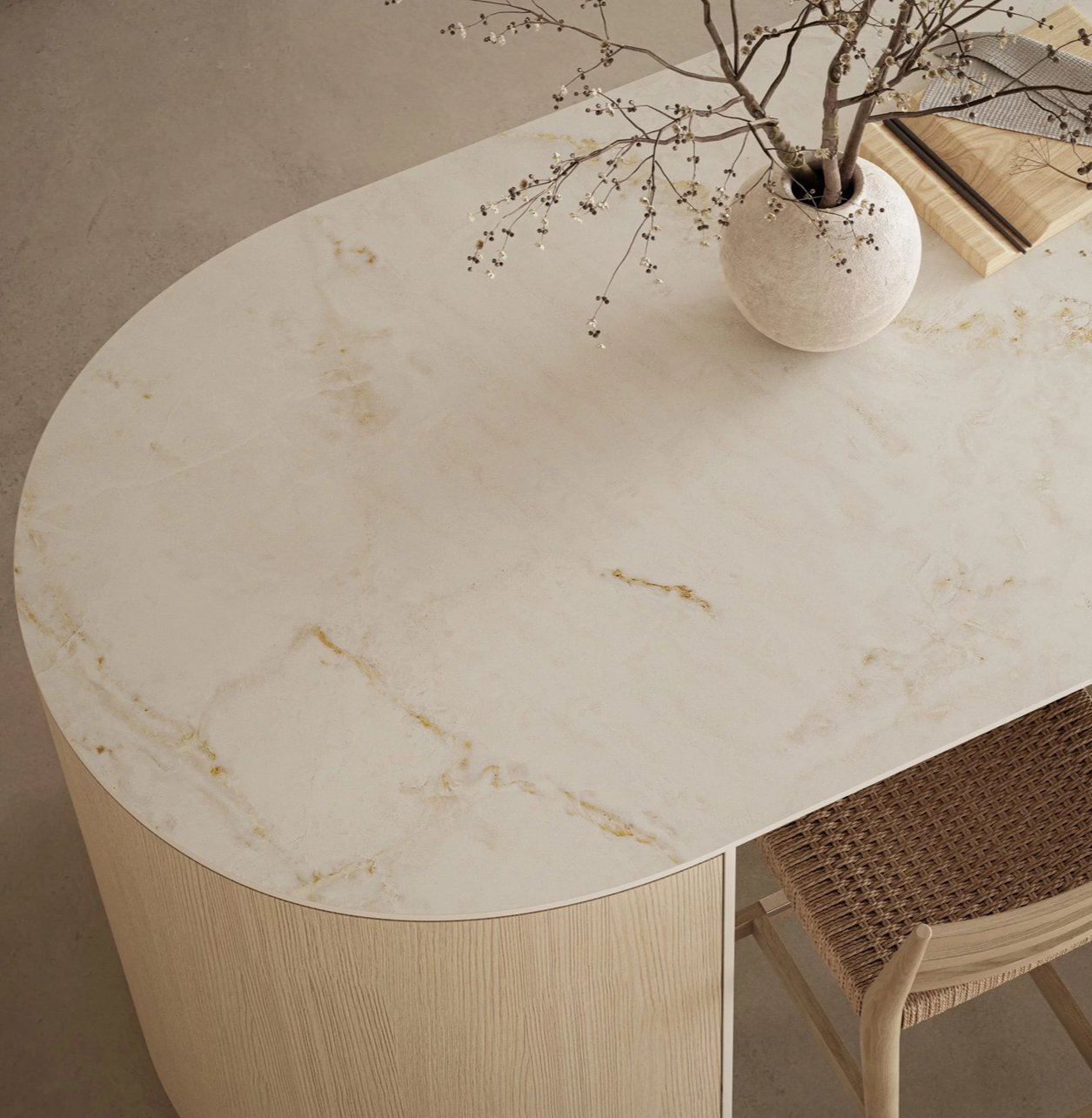 Caesarstone 537 Glacetta porcelain surface shows a luminous white base with soft golden veining across an elegant oval tabletop.