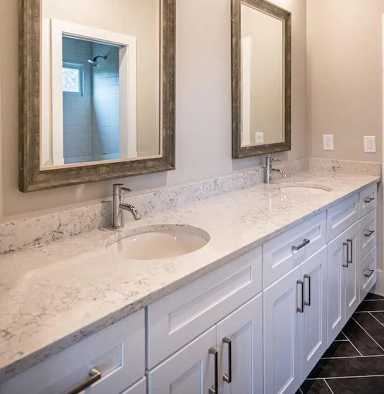 Silestone Helix countertop in a modern bathroom with double vanity and mirrors.