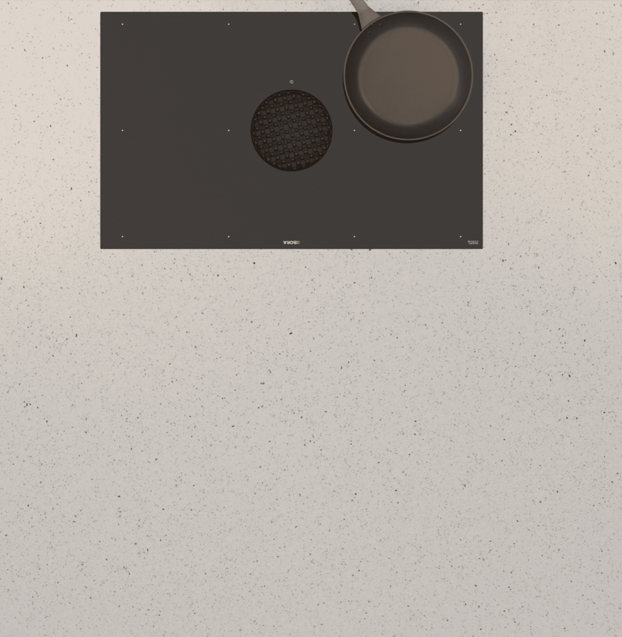 Silestone Stellar Blanco13 kitchen induction cooktop with frying pan and small round burner