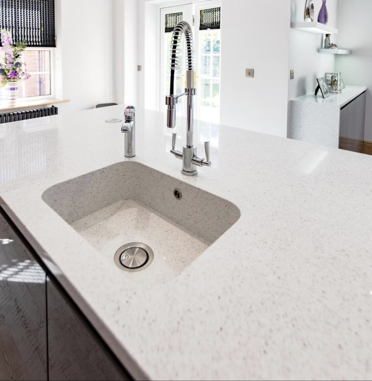 Silestone Stellar Blanco kitchen countertop with modern faucet and sink.