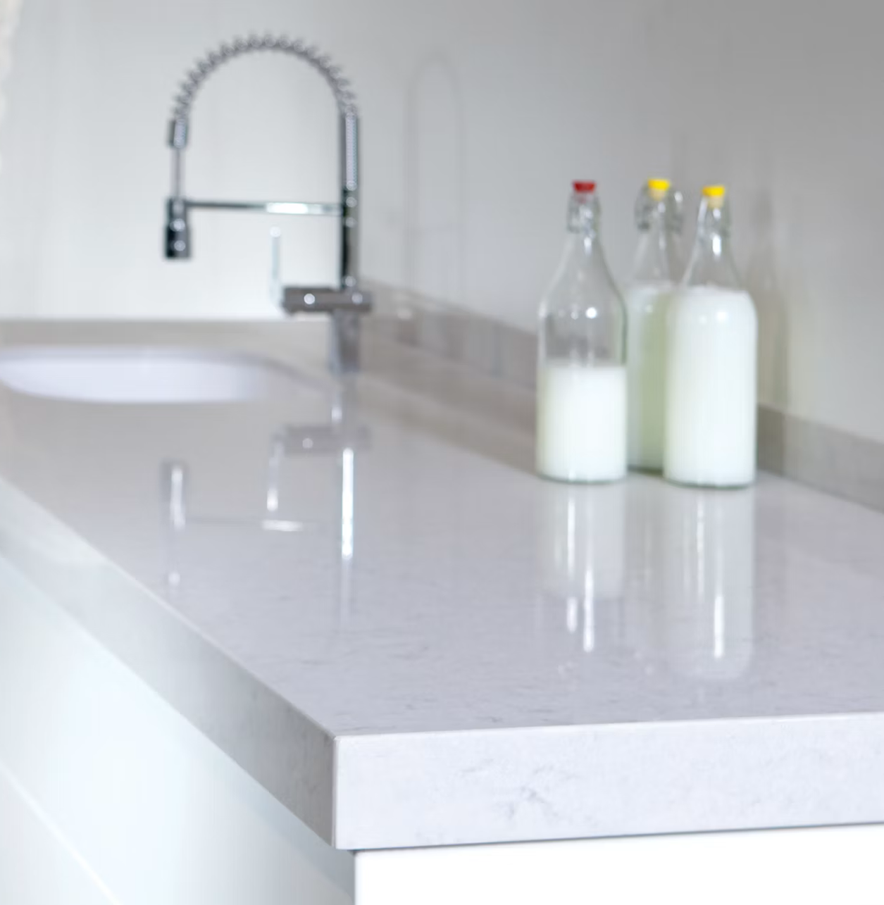 Silestone Lagoon countertop with a faucet and milk bottles