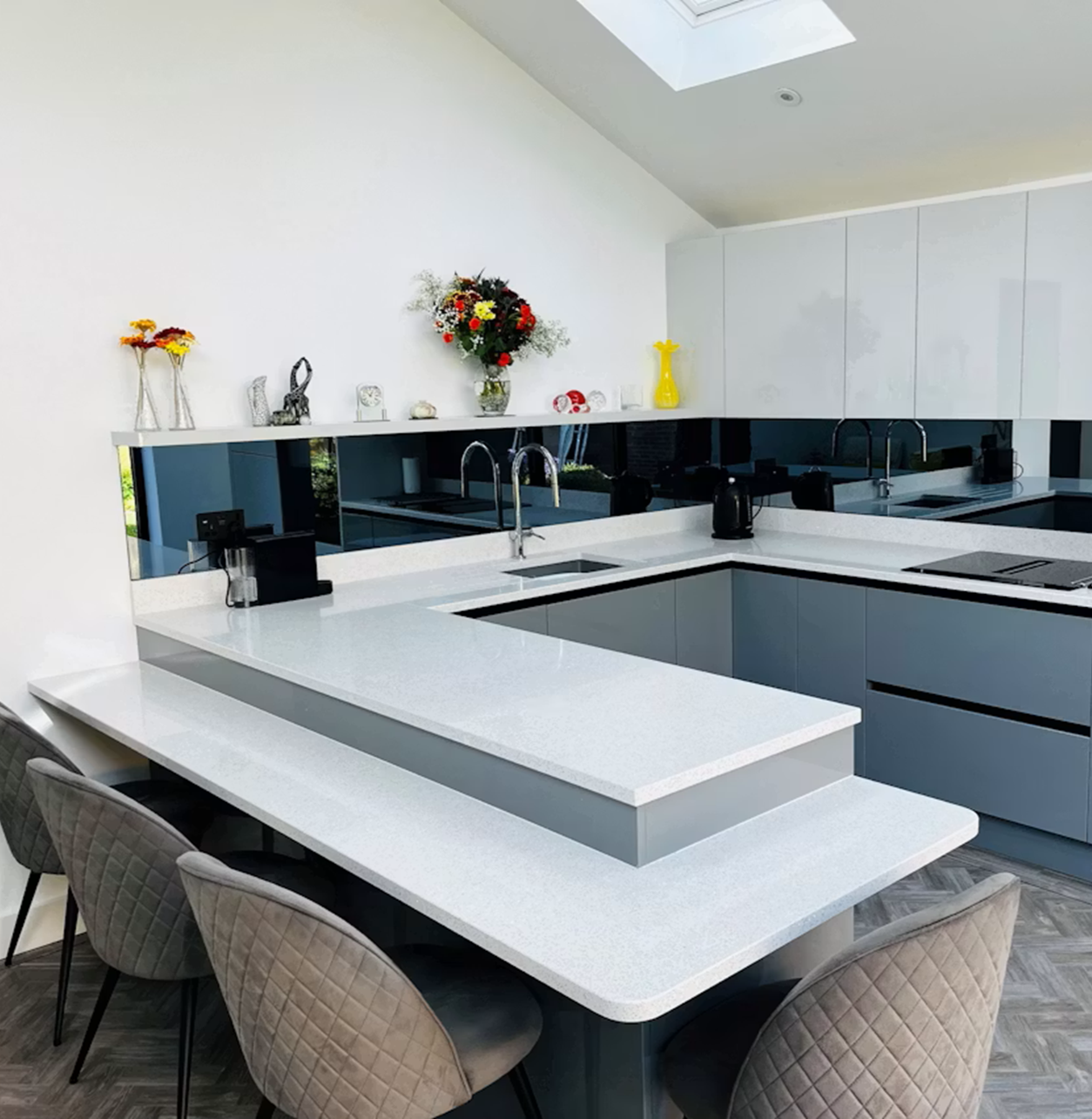 Modern grey kitchen with Silestone Stellar Blanco countertop and island