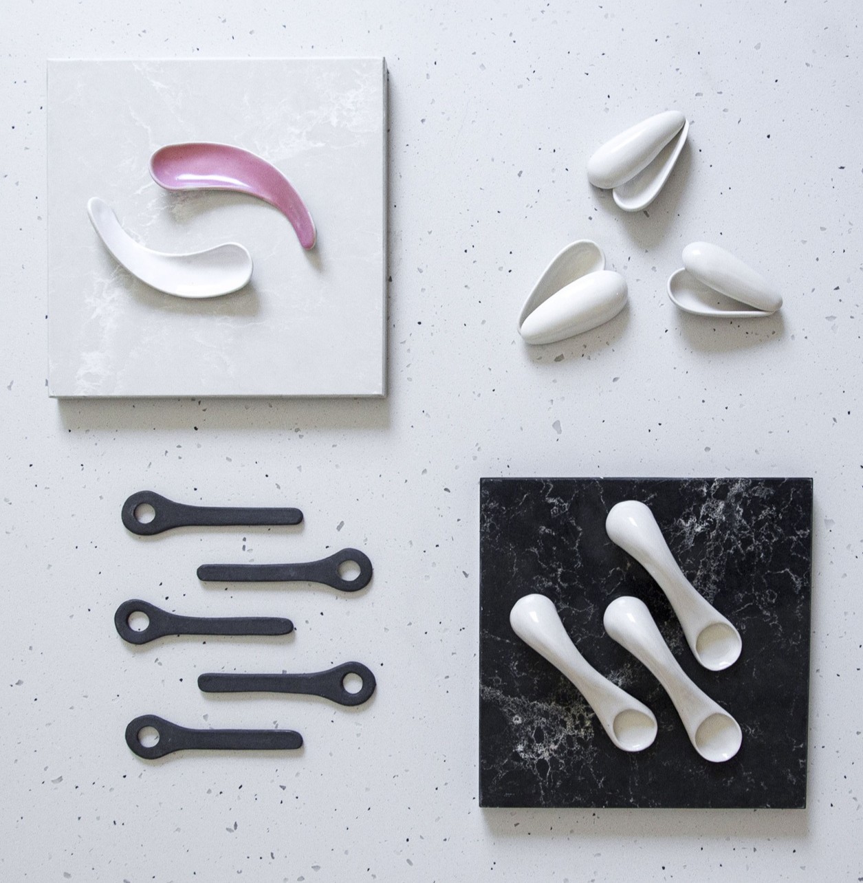 Collection of cosmetic spatulas and applicators in various materials and colors.