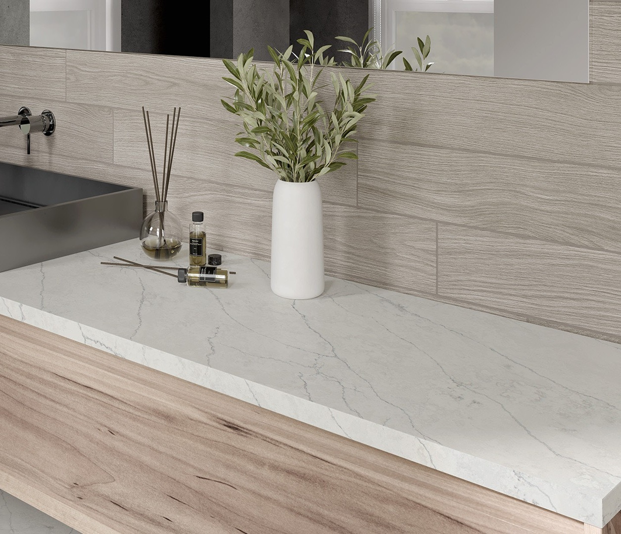 Avant Quartz 7540 Calacatta Concorde countertop with a white vase and plant.