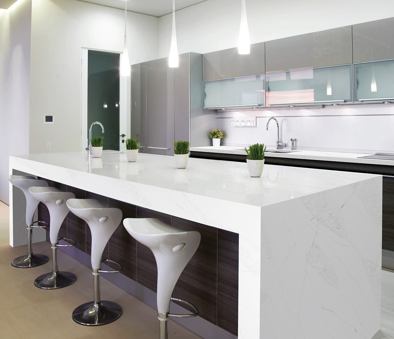 Avant Quartz 7570 Calacatta Monaco countertop in a modern kitchen with bar stools.