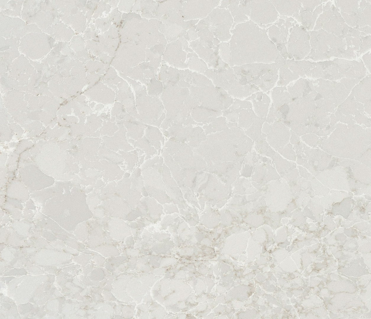 Close-up of a light gray quartz countertop with subtle white veining, reminiscent of marble.