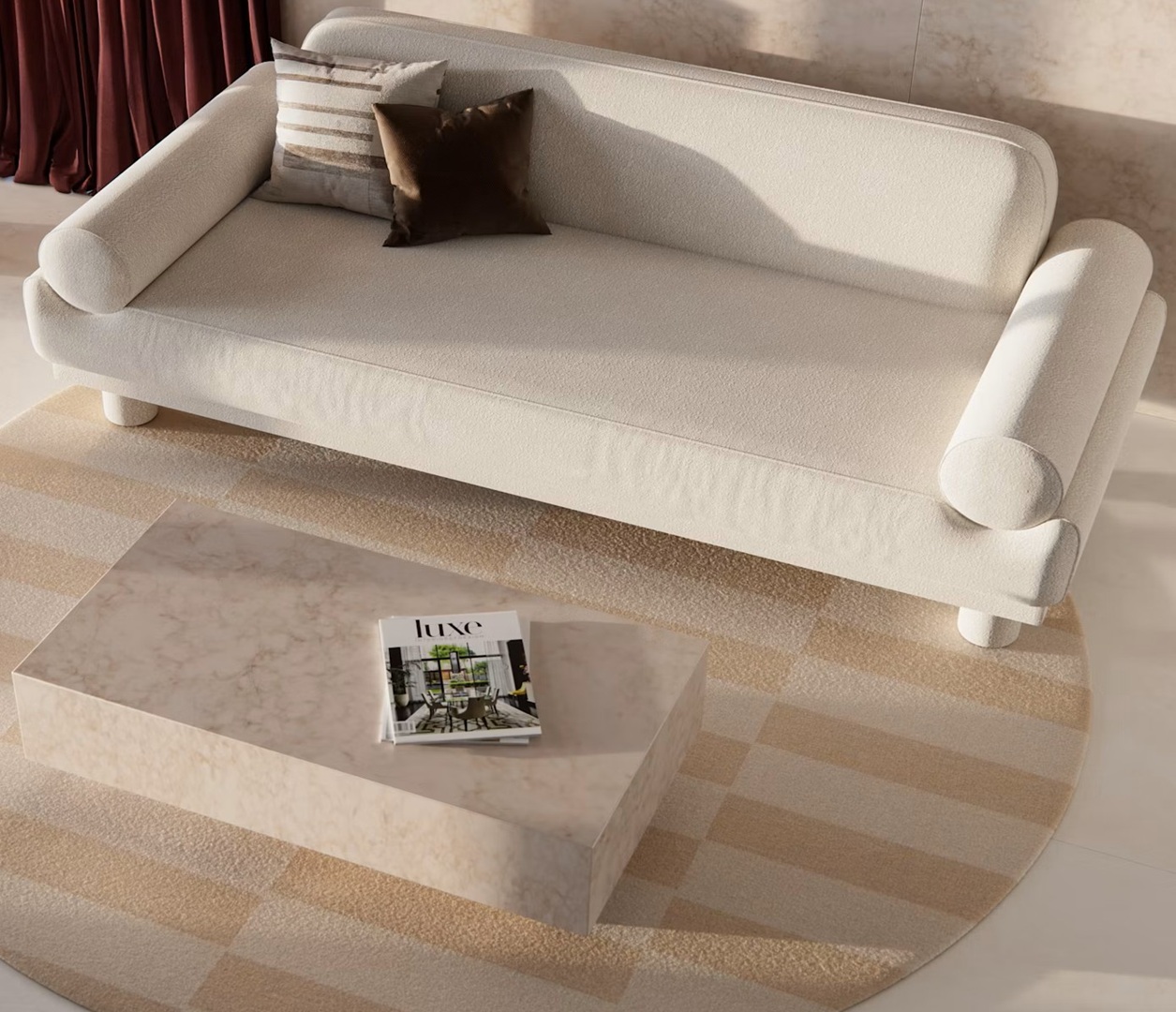 Cream boucle sofa with pillows on a rug near a marble coffee table