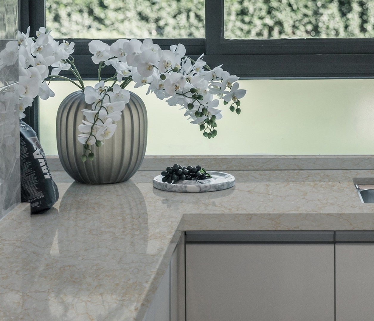 Avant Quartz 9030 Royal Beige countertop with white orchids and grapes